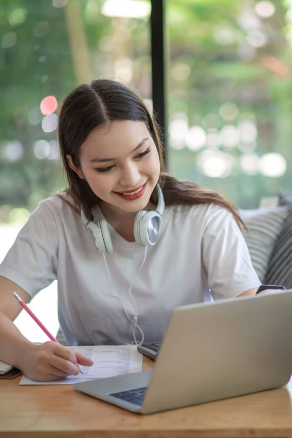 asian-woman-is-studying-online-and-taking-notes-on-2023-01-12-19-06-02-utc